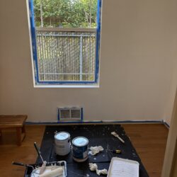 drop cloth covering floor with paint cans